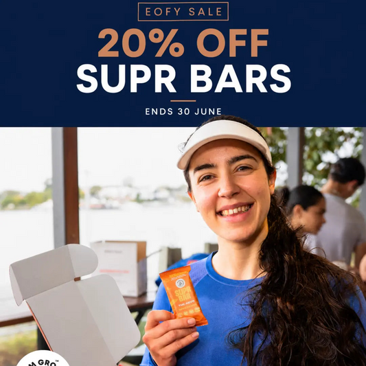 Person holding a Supr Bar with promotional text for a 20% off sale on Supr Bars.