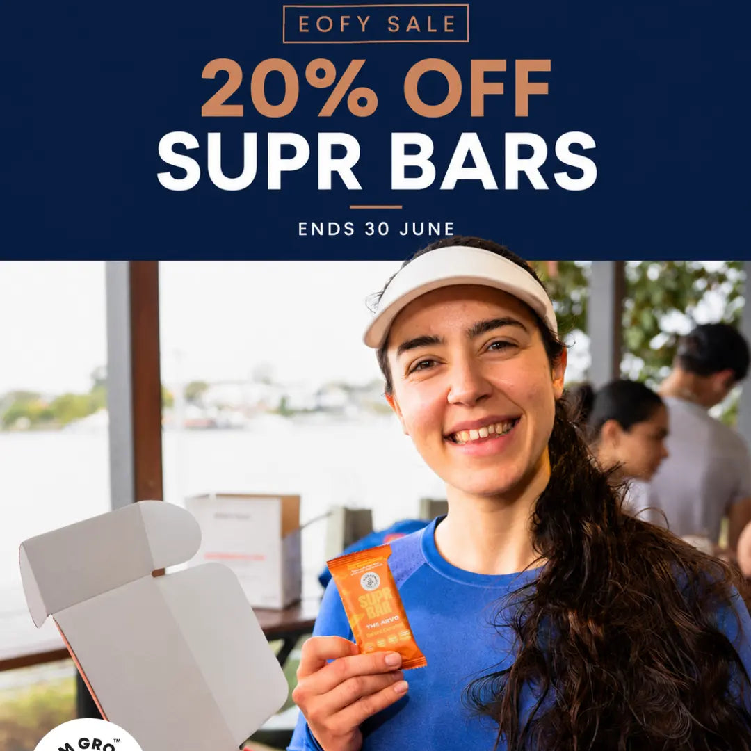 Person holding a Supr Bar with promotional text for a 20% off sale on Supr Bars.