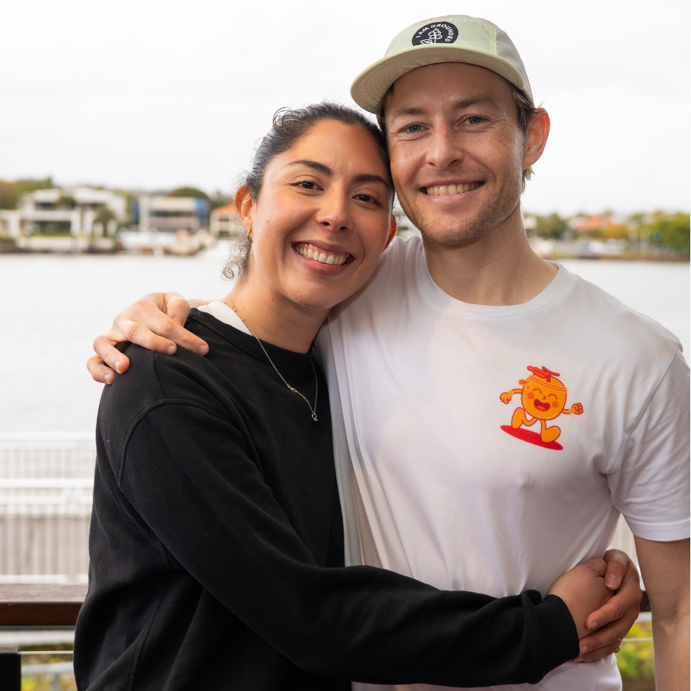 Two people posing together with a scenic background